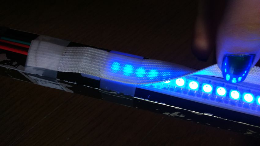 a close-up showing one extremity of sara, with a dozen leds in a row shining a bright blue